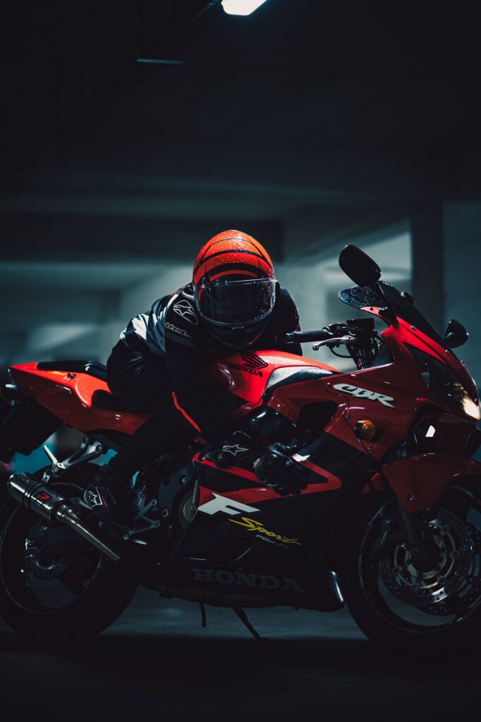 Dynamic Night Shot of Motorcyclist on Red Honda Dynamic Night Shot of Motorcyclist on Red Honda